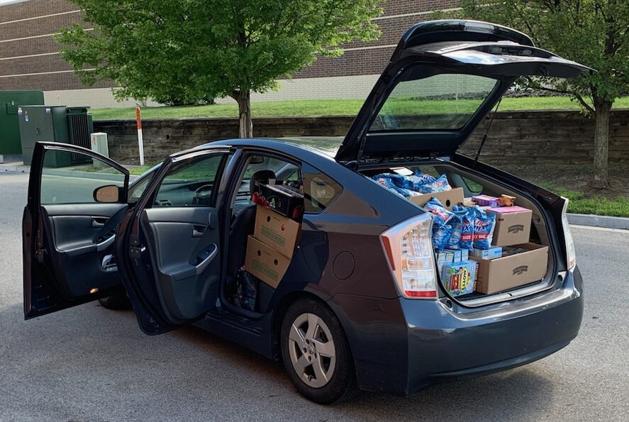 Car full of food featured in East Lansing News story on FRUS Lansing Communities